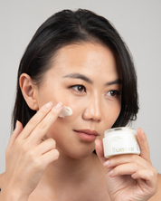 Founder - Khulan Davaadorj - is holding Morning Dew Lhamour facial hydrating cream and showing the texture