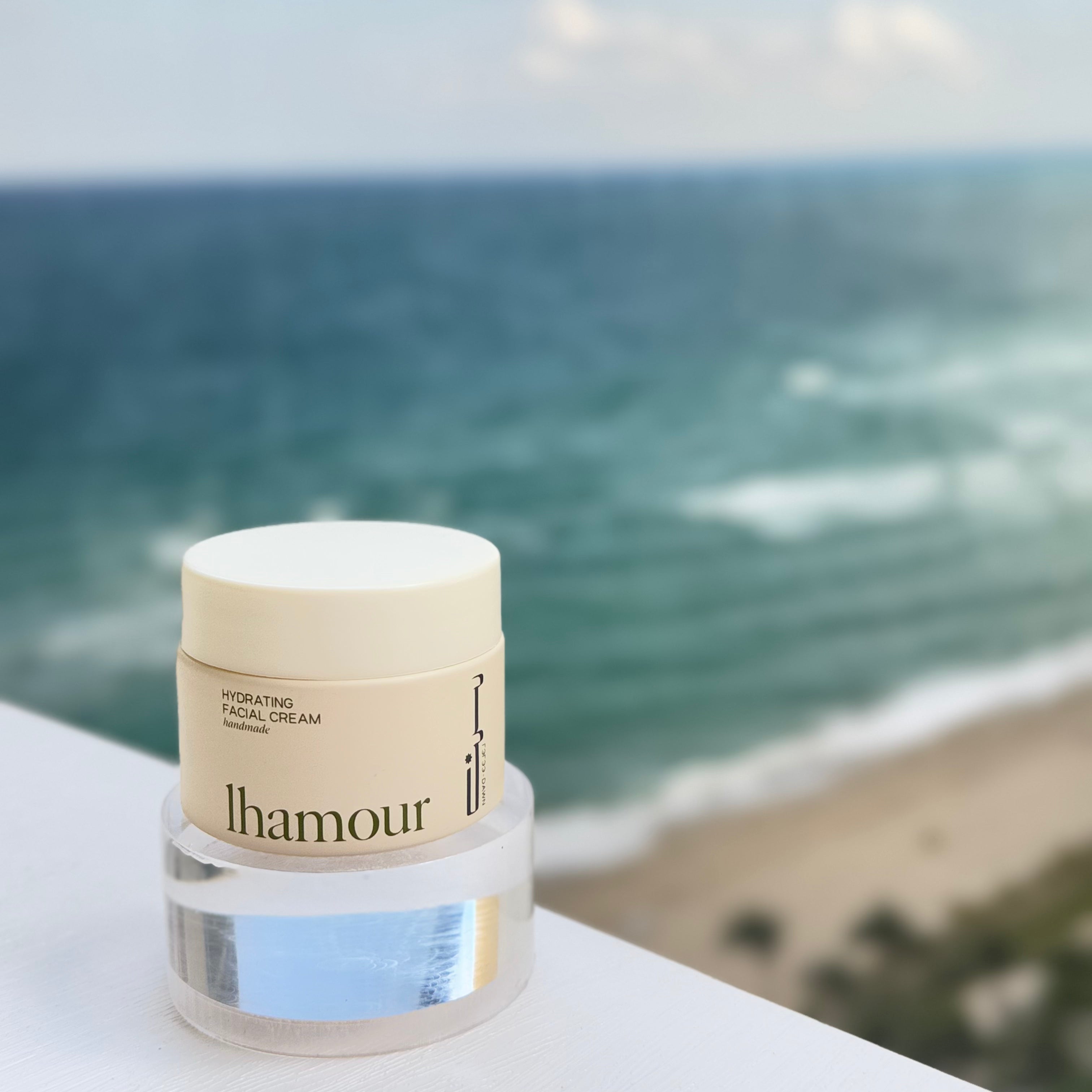 Jar of Morning Dew facial cream near the ocean — natural moisturizer for dry skin by Lhamour